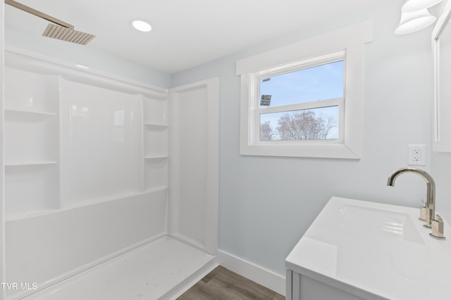 full bath with baseboards, visible vents, a shower, and wood finished floors