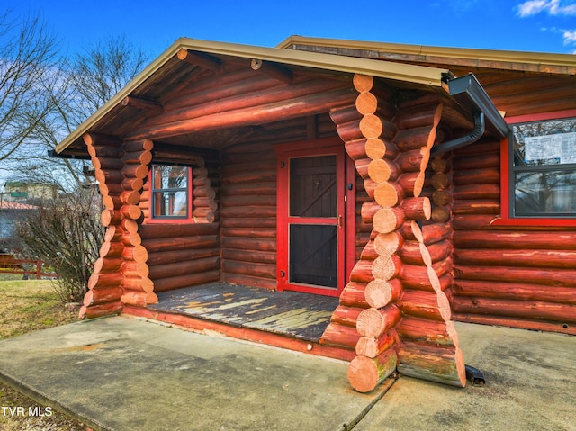 doorway to property with log exterior