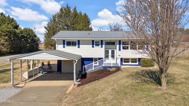 split foyer home with metal roof, a porch, driveway, french doors, and a front lawn