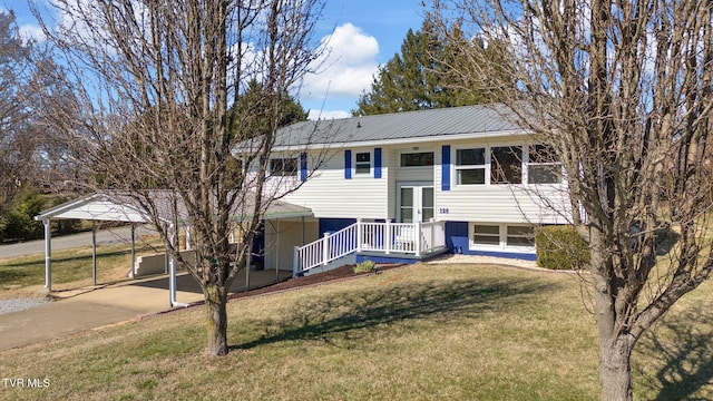 bi-level home with a carport, a front yard, and metal roof