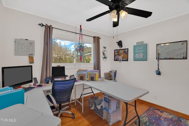 office area featuring ornamental molding, ceiling fan, baseboards, and wood finished floors