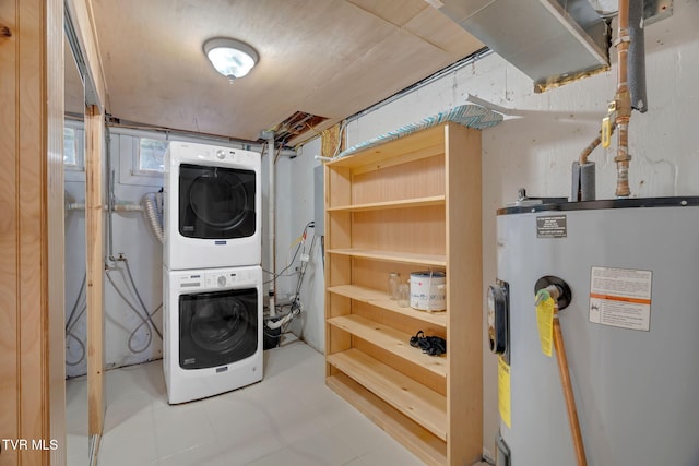 laundry area with water heater and stacked washer / dryer