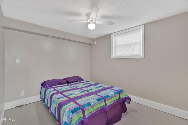 bedroom featuring a textured ceiling, a ceiling fan, and baseboards