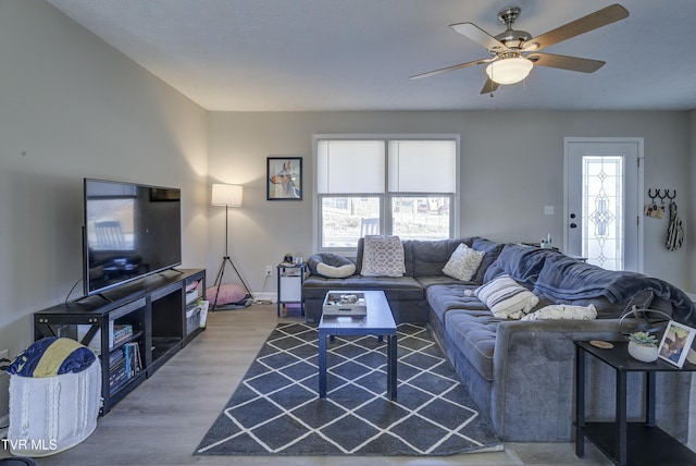 living room featuring ceiling fan and wood finished floors