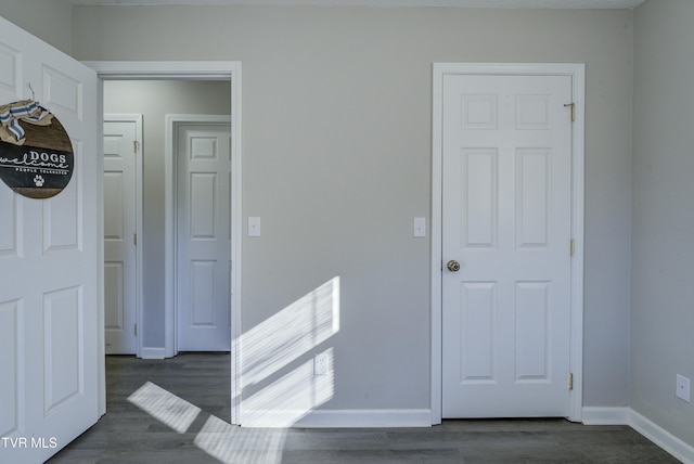 interior space with dark wood-style floors and baseboards