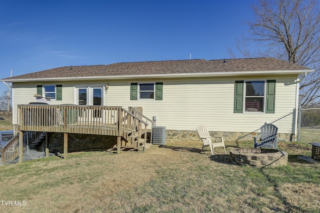 rear view of property featuring an outdoor fire pit, a wooden deck, stairway, a yard, and central air condition unit