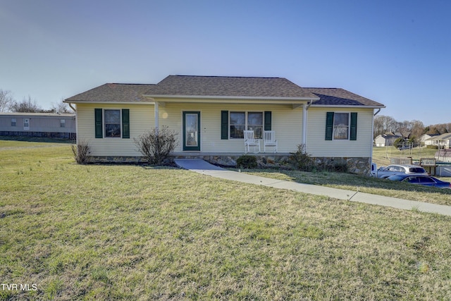 ranch-style house featuring a porch and a front lawn