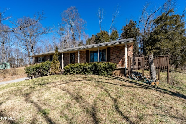 single story home with a front lawn and brick siding