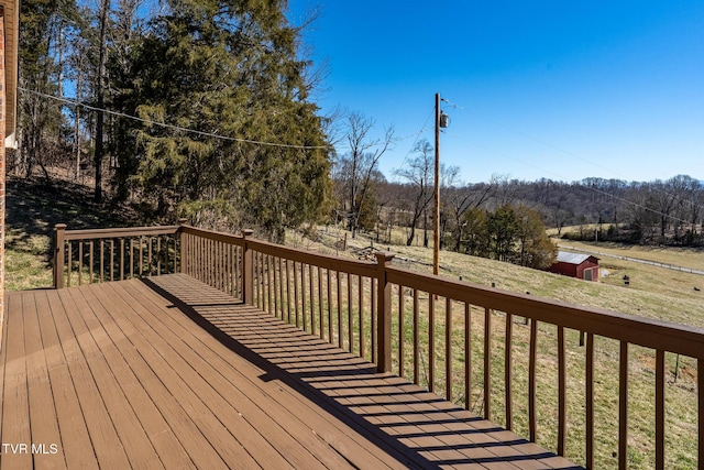 deck featuring a yard, an outdoor structure, and a shed