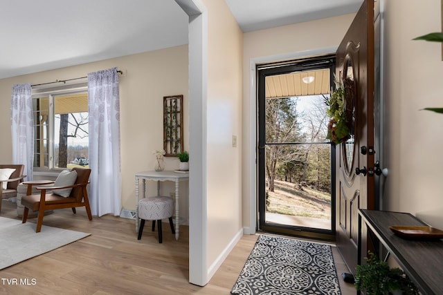 entrance foyer with light wood-style floors and baseboards