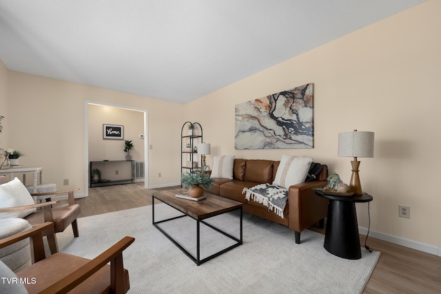 living area featuring light wood-type flooring and baseboards