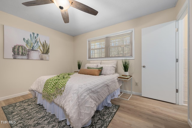 bedroom with light wood-style flooring, baseboards, and ceiling fan