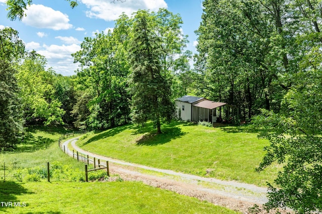 472 Harmony Rd, Jonesborough, TN 37659 - view of green lawn featuring a pole building, an outdoor structure, and a view of trees