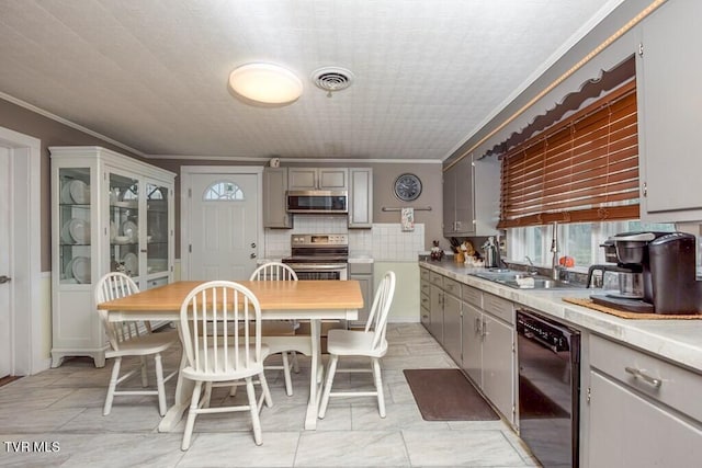 kitchen with visible vents, appliances with stainless steel finishes, gray cabinets, and ornamental molding