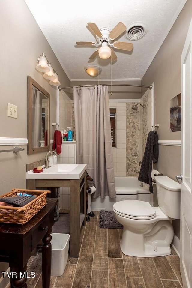 bathroom with shower / bath combo, visible vents, toilet, ceiling fan, and wood finish floors