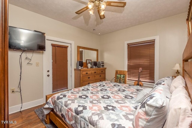 bedroom featuring a textured ceiling, ceiling fan, wood finished floors, baseboards, and a closet