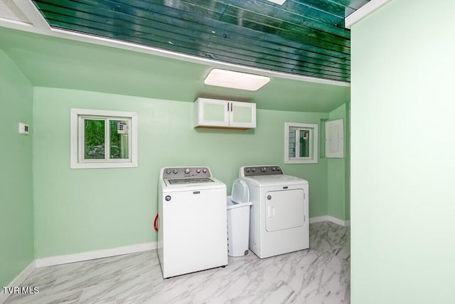 washroom with marble finish floor, baseboards, washer and clothes dryer, and cabinet space