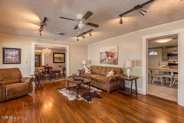 living room with visible vents, ornamental molding, and hardwood / wood-style flooring