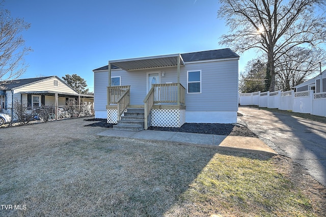 view of front of property featuring a deck and fence