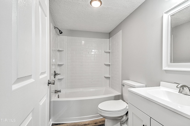 full bathroom with toilet, wood finished floors, a textured ceiling, vanity, and shower / washtub combination