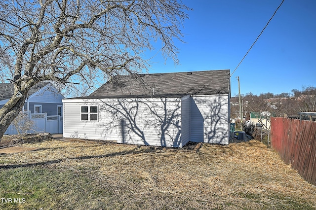 rear view of house with fence and cooling unit