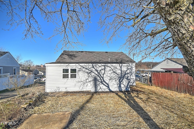 back of property featuring fence