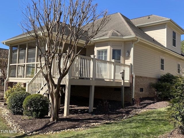 back of house with a deck, brick siding, a shingled roof, a sunroom, and crawl space