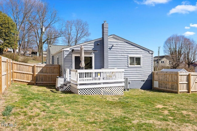 rear view of property featuring central AC unit, a fenced backyard, a wooden deck, and a lawn