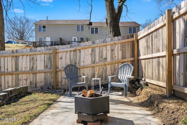 view of patio featuring an outdoor fire pit and a fenced backyard