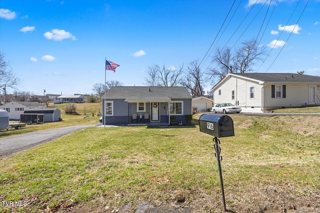 view of front of property featuring aphalt driveway and a front yard