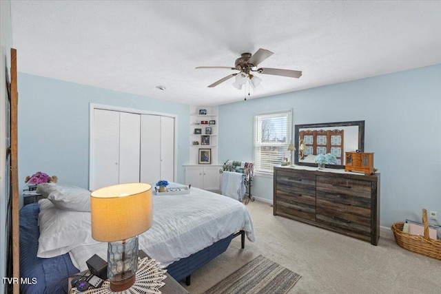 bedroom with a ceiling fan, a closet, carpet flooring, and baseboards