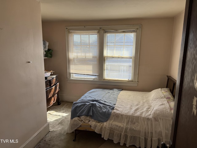 bedroom featuring carpet and baseboards