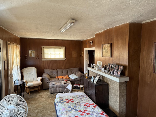 living room with a textured ceiling, wood walls, and carpet flooring