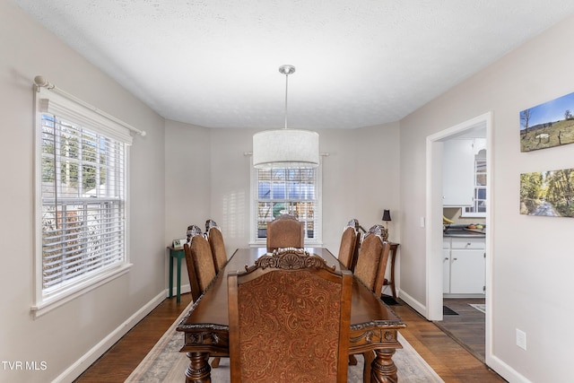 dining room with dark wood-style floors and baseboards