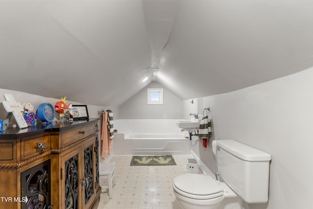 bathroom with a bath, lofted ceiling, toilet, and tile patterned floors