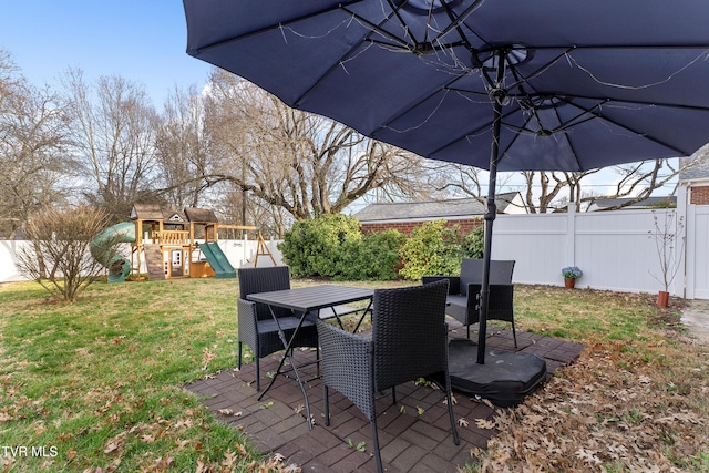 deck with a yard, outdoor dining space, a patio, and a fenced backyard