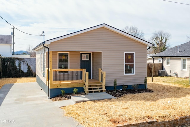 bungalow with covered porch, crawl space, fence, and central air condition unit