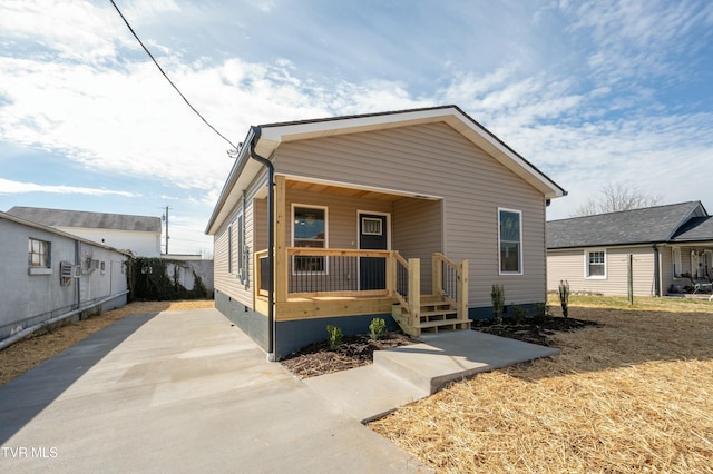 view of front of home with crawl space, a porch, and cooling unit