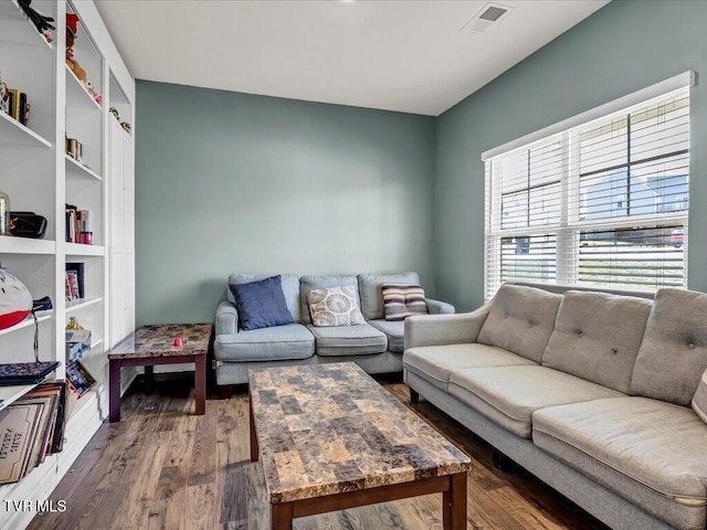 living room with visible vents and wood finished floors