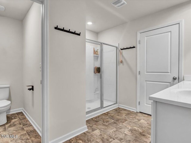 bathroom with visible vents, baseboards, toilet, stone finish floor, and a shower stall