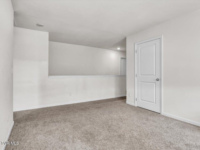 carpeted spare room with baseboards