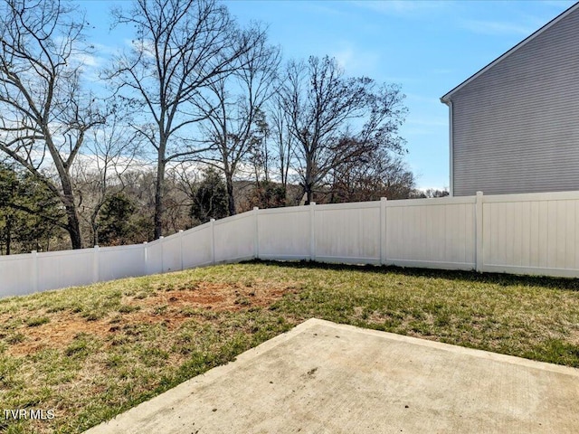 view of yard featuring fence and a patio