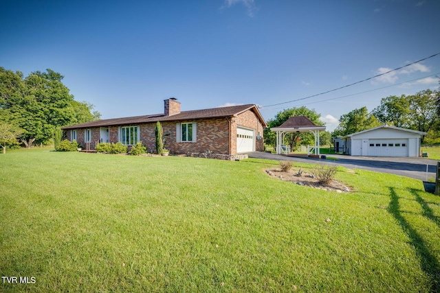 ranch-style house featuring a front lawn, brick siding, a chimney, and a gazebo