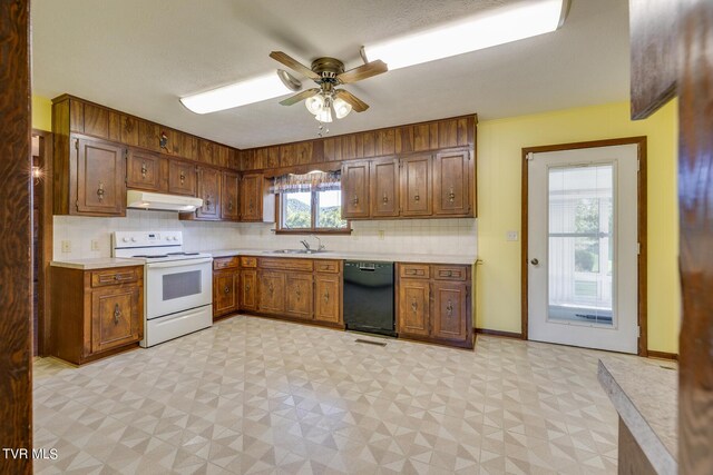 kitchen with black dishwasher, electric stove, light floors, light countertops, and under cabinet range hood