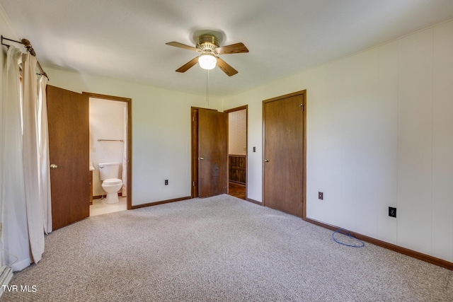 unfurnished bedroom with ceiling fan, a baseboard radiator, baseboards, carpet, and ensuite bath