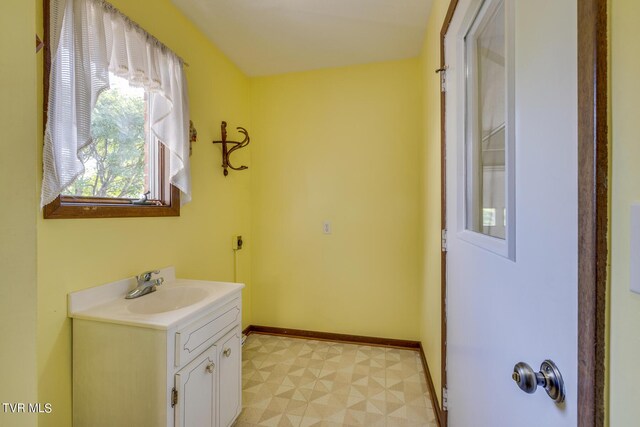 bathroom featuring vanity, baseboards, and tile patterned floors