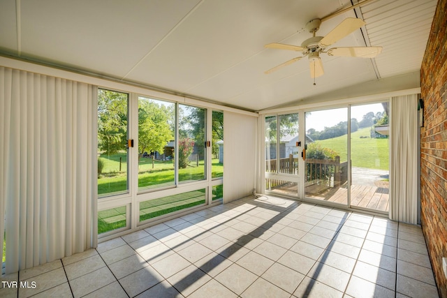 unfurnished sunroom with lofted ceiling and ceiling fan