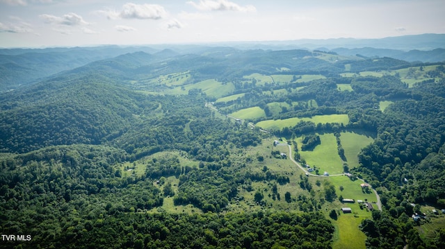 aerial view featuring a mountain view and a view of trees