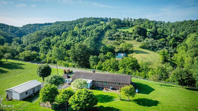 drone / aerial view featuring a view of trees