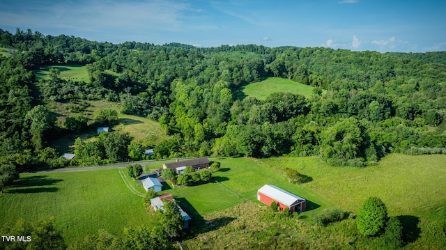 drone / aerial view featuring a rural view and a wooded view